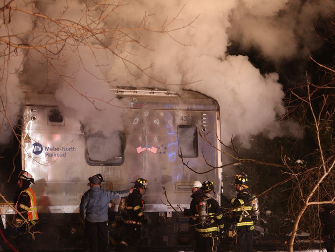 Firefighters work at the scene of a train vs car accident