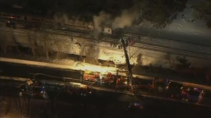 A still image captured from WNBC-TV aerial video shows first responders battling fire on a New York City -Metro-North train following an accident near Valhalla, New York February 3, 2015. REUTERS-WNBC-TV