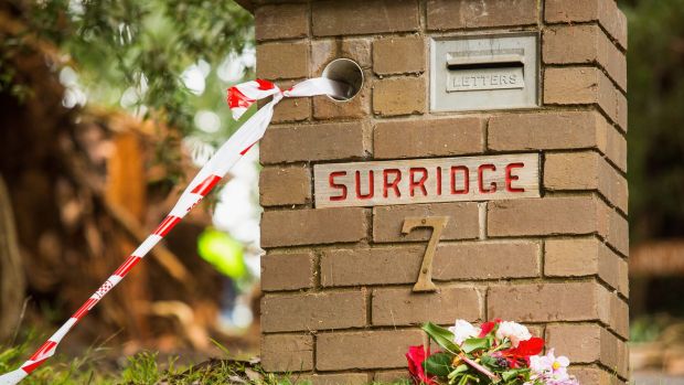 Flowers laid out the front of the home where a toddler was killed by a falling tree on Saturday.