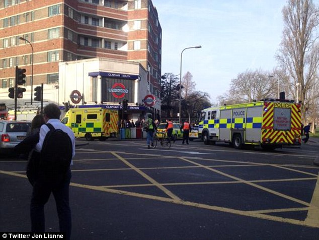 Emergency services on the scene: One witness told of how fire crews hoisting up a Tube train to free the woman, while another said the woman was pulled underneath the train as it approached
