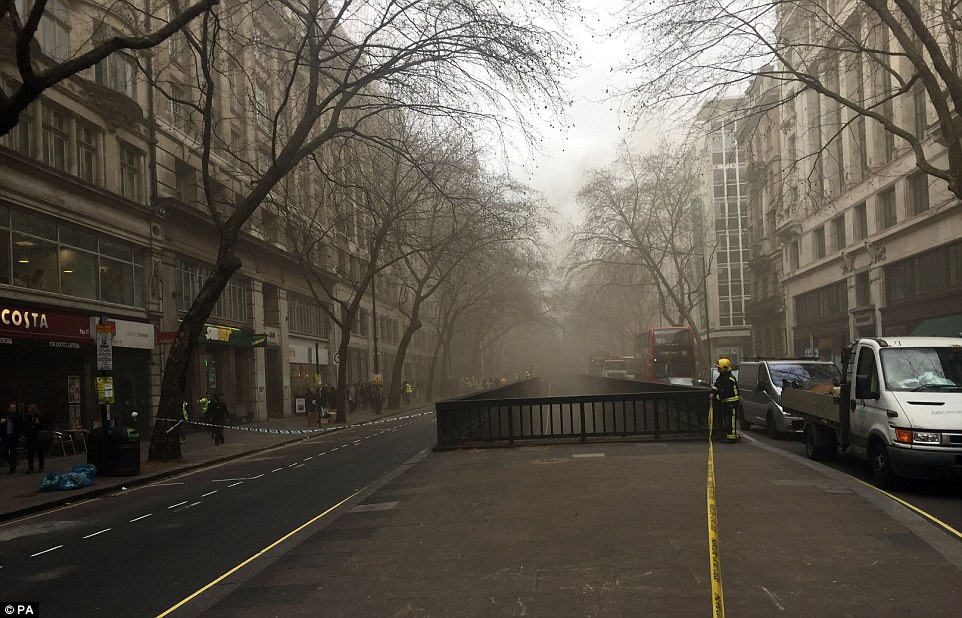 Cordoned off: Office workers were left waiting on the streets of Holborn, while nearby shops and cafes were plunged in to darkness