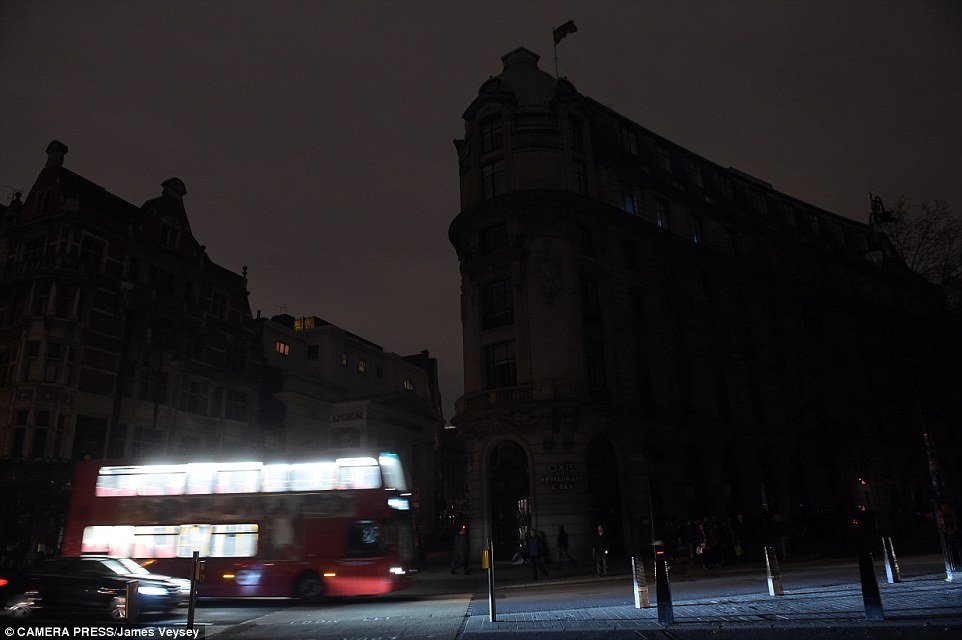 Darkness: A London bus and a car drive through the West End near the Lyceum Theatre, where The Lion King was cancelled last night