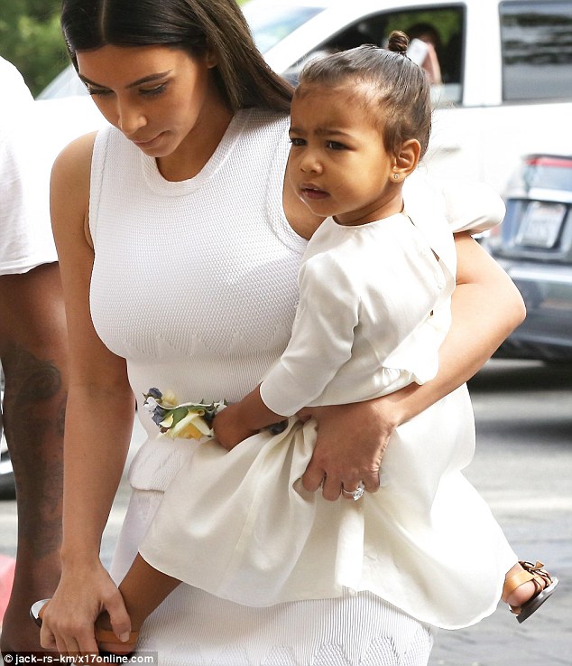 Like mother, like daughter: Kim dressed her little girl in a matching white dress that featured long sleeves