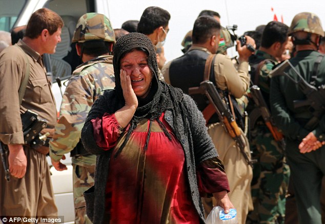 Relief: A newly released Yazidi woman reacts upon her arrival in the village of Himera, southwest of Kirkuk, after she and hundreds of other Yazidis had been held captive since last summer