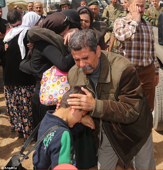 Yazidi families embrace after ISIS let them go. About 40 children were among those released