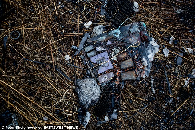 Debris: A burned printed circuit board lies in the grass at the main crash site near Grabovo village 