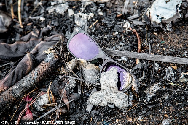 Haunting: Personal belongings of victims are still littered around the field - and possibly crucial evidence -because the crash scene hasn't been cleared nine months after the Malaysian Airways flight came down