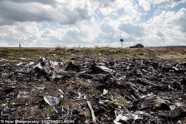 Horror: Almost nine months after the passenger jet was shot out of the sky by a missile, the 'smell of death still hangs over' this bleak area of eastern Ukraine