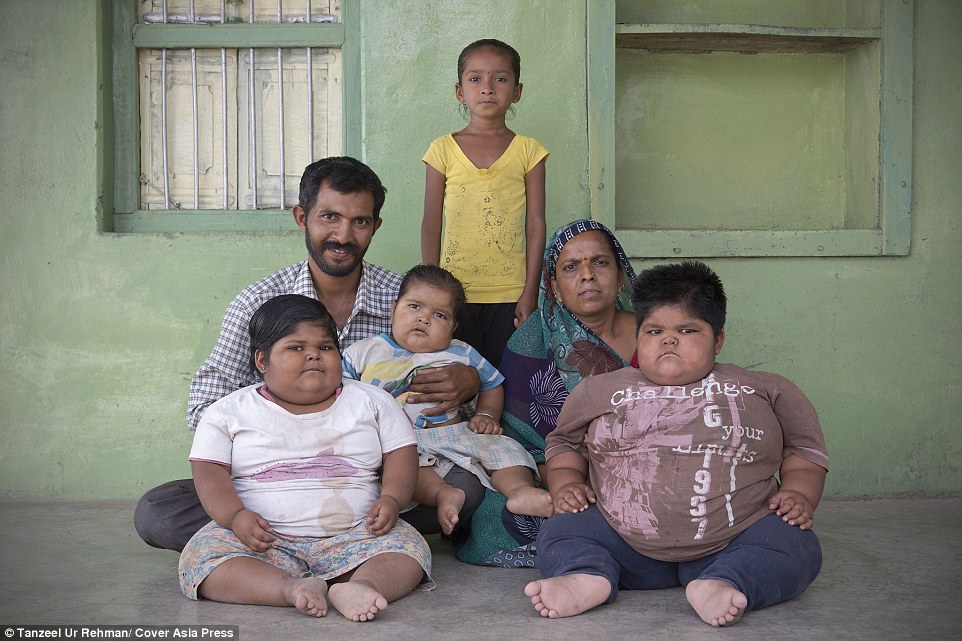 Family: Rameshbhai Nandwana (left), 34, and Pragna Ben (back right), 30, are the parents of Yogita (front left), Anisha (front right), Harsh (front centre) and six-year-old Bhavika (rear centre), their other daughter - who weighs an average 2st 7lbs. They all live together in Gujarat, India
