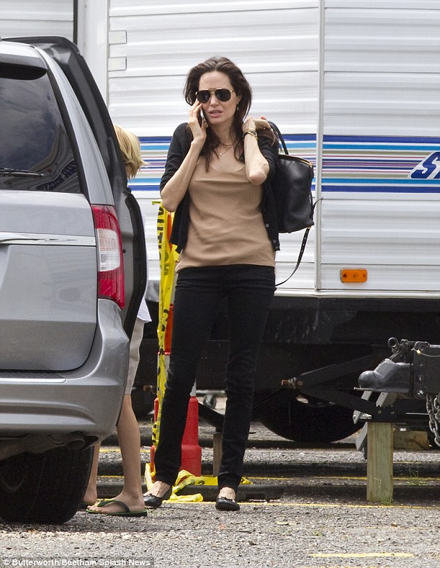 Casually chic: For her set visit, the Tomb Raider star looked casual but still chic in a pair of black jeans with a nude colour tank and a black cardigan