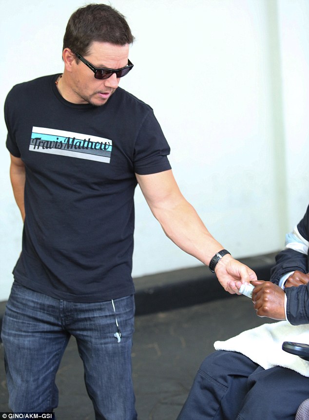 Relaxed: He looked fit and trim casually dressed in a t-shirt and combat pants, with tan work boots as he left the venue