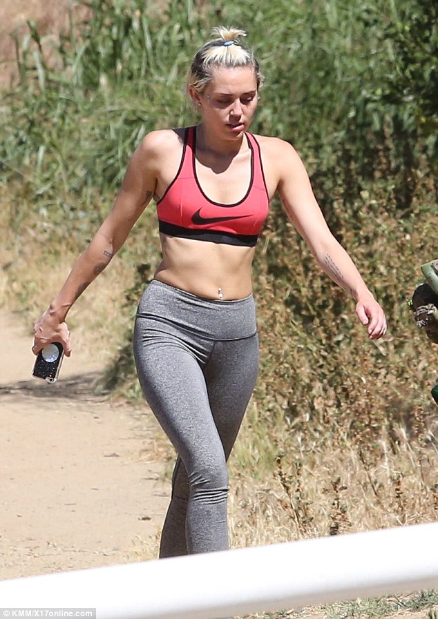 The queen of lean: Super-fit Miley Cyrus took an idyllic - if not energetic - hike through the Hollywood hills in Los Angeles on Tuesday