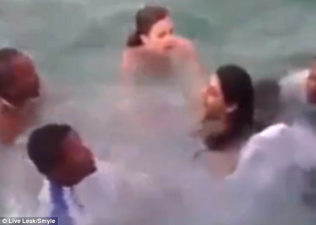 It took six people to pull the wedding dress out of the way and bring the bride to the surface of the water