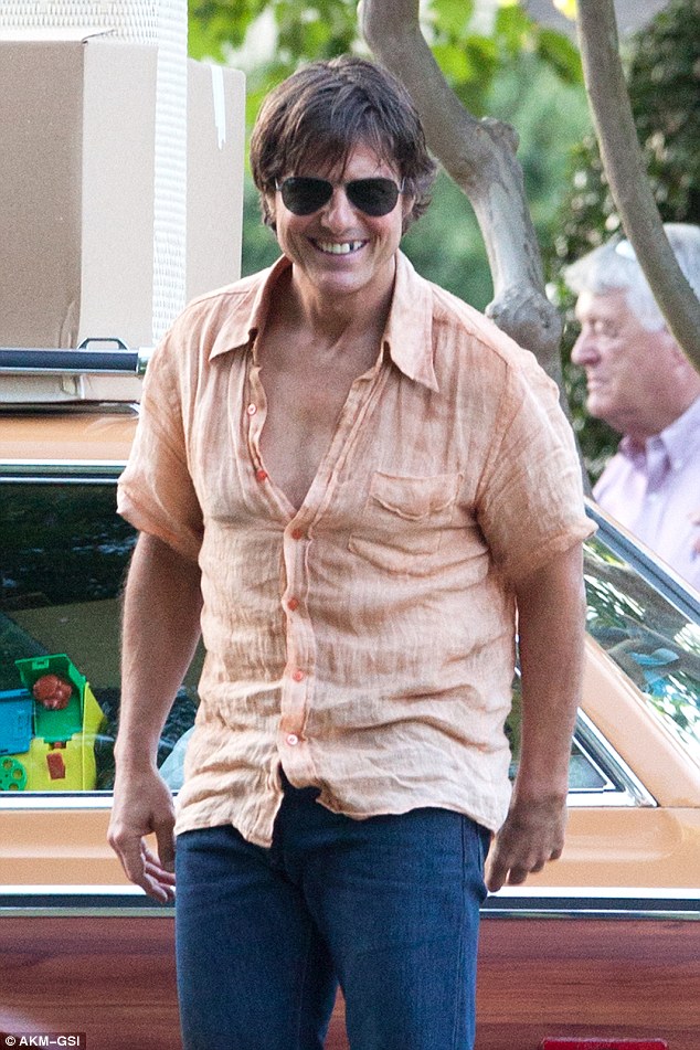 'Toothless' Tom: Mr. Cruise sported a blacked out tooth for his role as gun runner and drug trafficker Barry Seals on set of the 1980s-era film Mena in Atlanta, Georgia on Tuesday