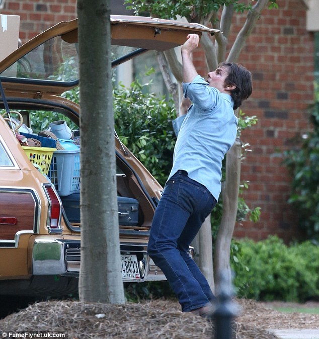 Leaving town: Tom filmed a scene that had him packing up the back of a station wagon