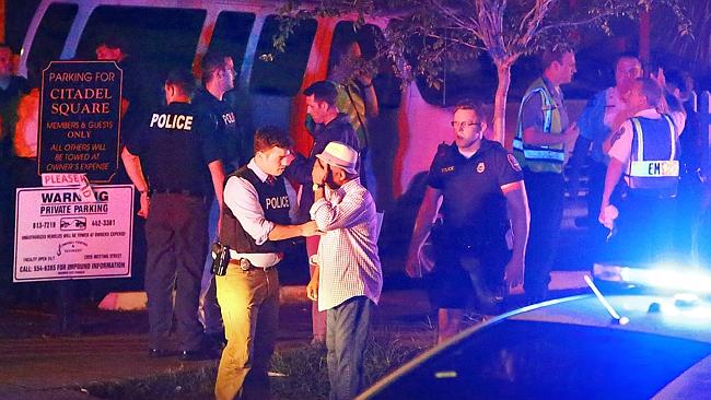 Police talk to a man outside the Emanuel AME Church. Picture: Wade Spees/The Post And Cou