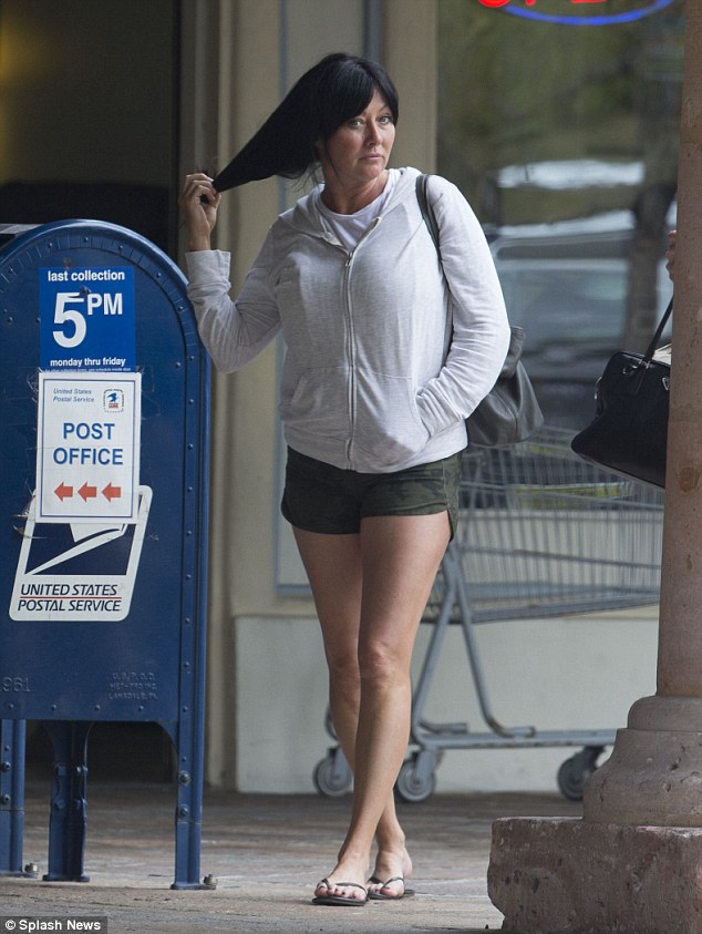 Casual day: The 44-year-old former star of Charmed and Beverly Hills, 90210 emerged from the salon with a similarly sullen expression after her pampering session that included a pedicure