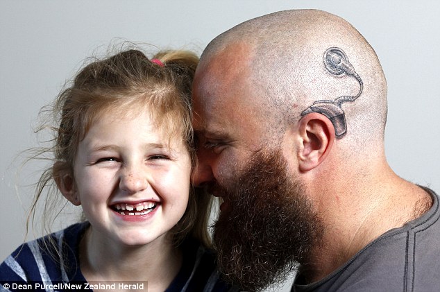 Father Alistair Campbell got a tattoo of a cochlear implant on his head to show his support for daughter Charlotte, six, who is forced to wear two of the devices to combat her profound deafness