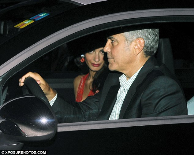 Behind the wheel: George drove the couple to and from the restaurant, snubbing an entourage