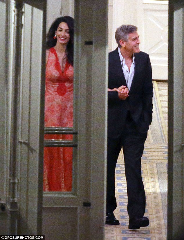 One of the locals: George and his wife enjoyed a joke with staff as they left the hotel, a regular haunt for the Hollywood star during his stints in Italy