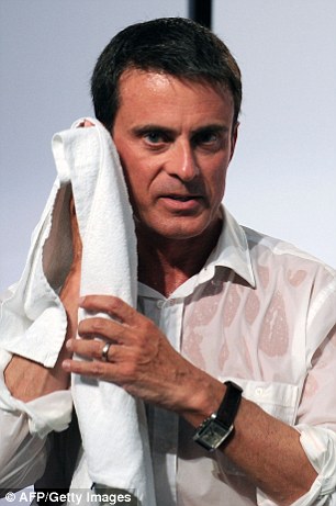 Manuel Valls wipes himself down with a towel