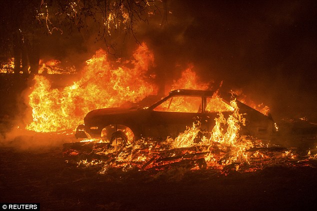 Cars burn as the Butte Fire rages through the Scott's Junction area near Mountain Ranch, California