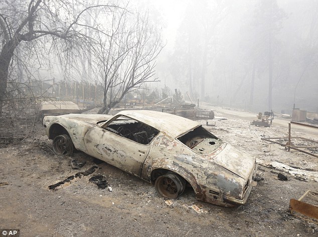 A car destroyed by the Butte Fire sits on tireless rims at a home in Mountain Ranch, Saturday
