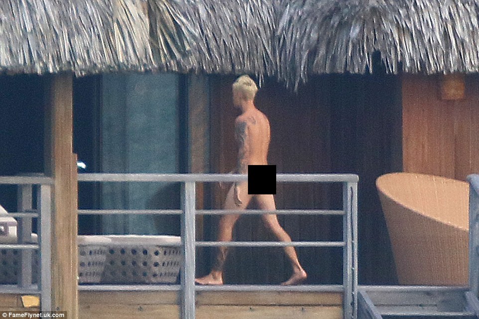 Taking a stroll: The What Do You Mean hitmaker displayed his collection of tattoos and buff body as he walked around his getaway home