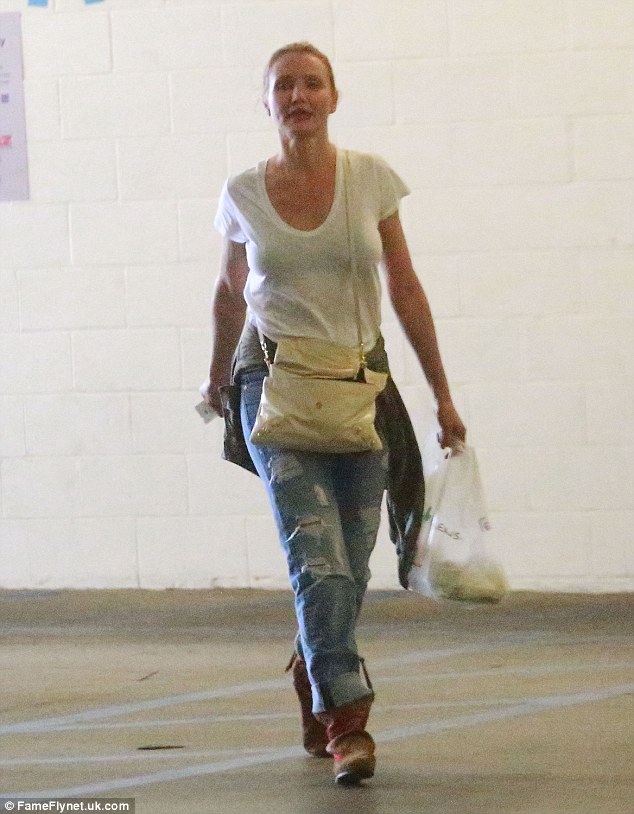 Gorgeous: Tying a khaki jacket around her waist, she wore a cream Balenciaga handbag across her body and finished off her look with a pair of brown suede ankle boots