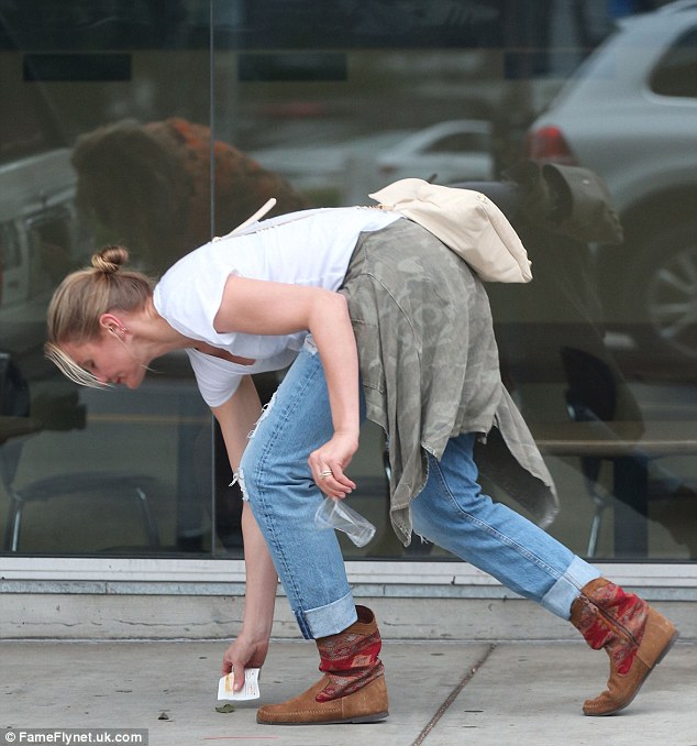 Friend of the earth: Cameron Diaz, 43, was pictured picking up litter, while out getting her lunch in Hollywood, where she was seen rocking a casual ensemble