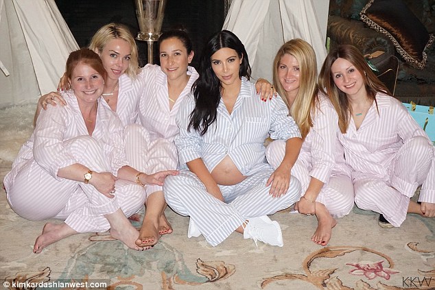 Cosy gathering: The second-time mom-to-be was seen sitting crosslegged with her prominent bump exposed in another cosy snap she shared on her website