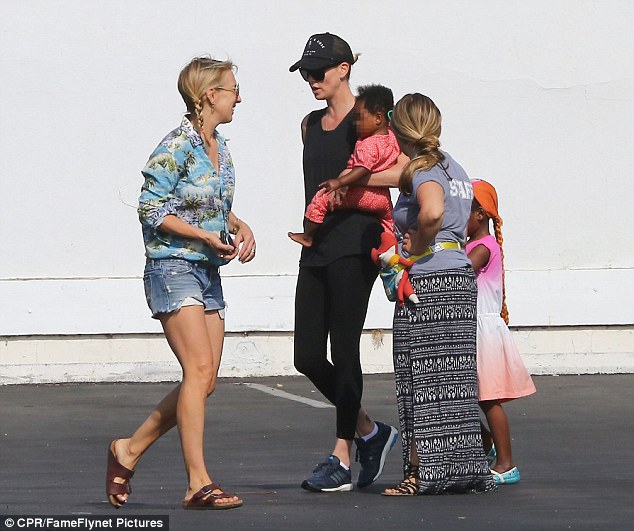 Saying bye: The 40-year-old actress cradled her little one close as she chatted with the facility's staff 