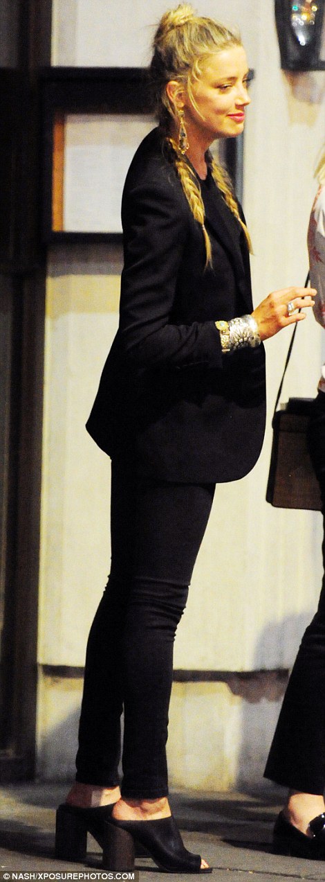 What divorce? It seems that a bouyant Amber Heard was ready to put the acrimonious end of her marriage behind her, as she joined her A-List pals Margot Robbie and Cara Delevingne for a fun-filled evening out in London