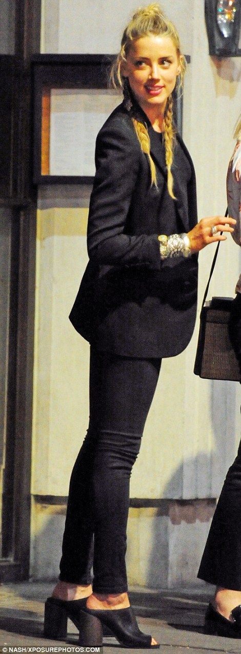 What divorce? It seems that a bouyant Amber Heard was ready to put the acrimonious end of her marriage behind her, as she joined her A-List pals Margot Robbie and Cara Delevingne for a fun-filled evening out in London