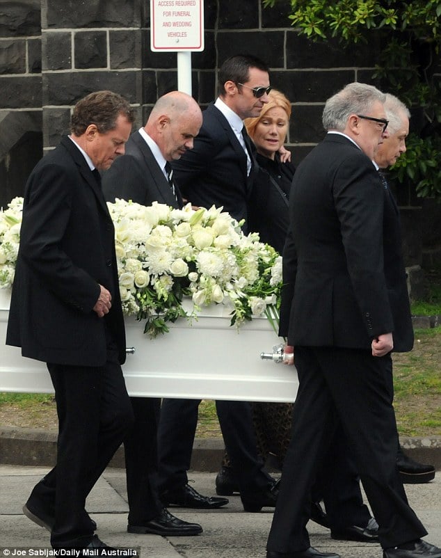 Comfort: Australian actor Hugh Jackman comforted his bereaved wife Deborra-Lee Furness as she bid a final farewell to her late mother Fay Duncan at her funeral in Melbourne on Thursday