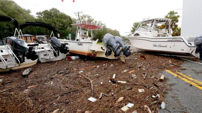 Debris and boats are scattered across the road after Hurricane Hermine passed the area on Friday, 2 September 2016 in Steinhatchee, Fla.