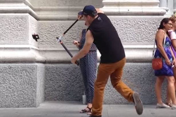 A man cuts selfie sticks of tourists in half in New York