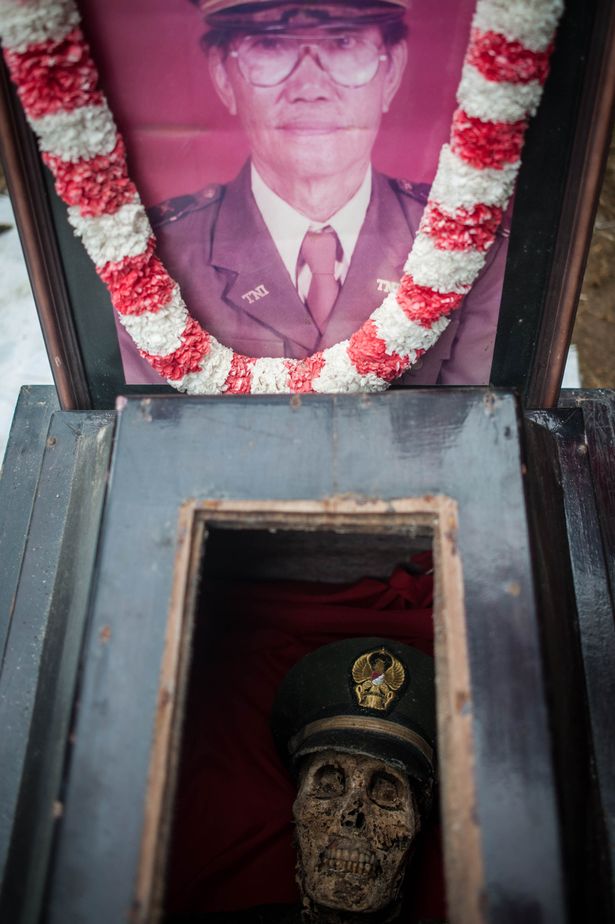 Relatives exhume the body of L Sarungu, an army veteran dead for 10 years, during the Ma'nene ritual at Panggala Village on August 25, 2016 in Toraja, Indonesia.