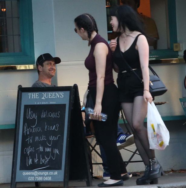 Gerald Butler is seen eyeing up every female that passes at the Queen's pub in Primrose Hill before flirting with another female and her dog inside the pub