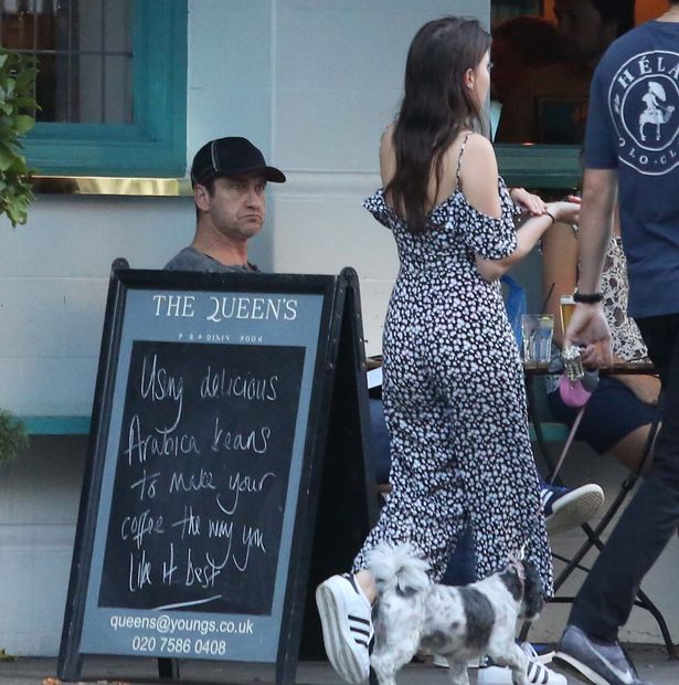 Gerald Butler is seen eyeing up every female that passes at the Queen's pub in Primrose Hill before flirting with another female and her dog inside the pub