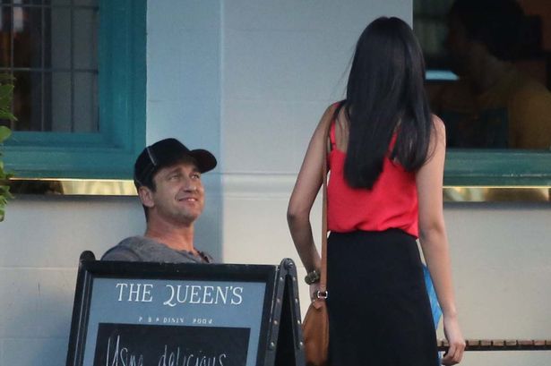 Gerald Butler is seen eyeing up every female that passes at the Queen's pub in Primrose Hill before flirting with another female and her dog inside the pub