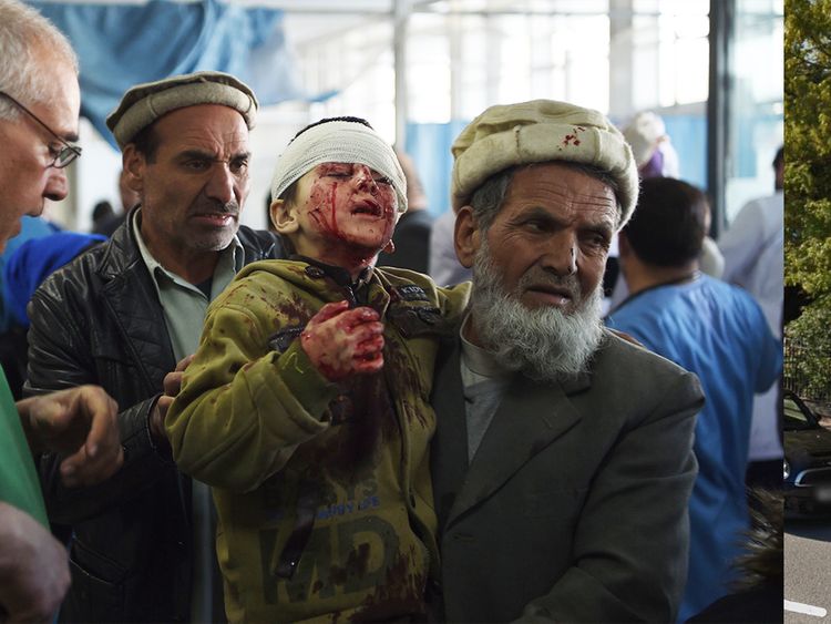 An Afghan man holds a wounded child, after a car bomb exploded near the old Interior Ministry building, at Jamhuriat Hospital in Kabul on January 27, 2018