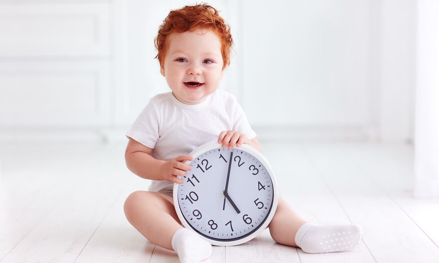 child with a clock