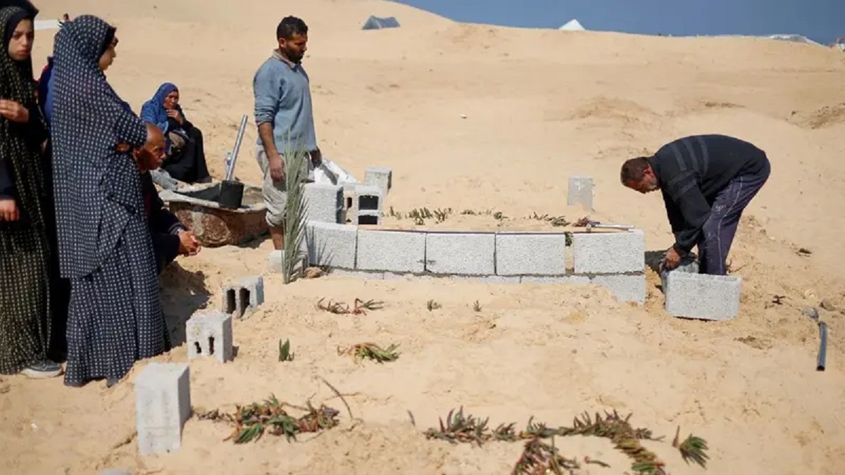 Palestinians gather at Tal al-Sultan cemetery in Rafah in the southern Gaza Strip